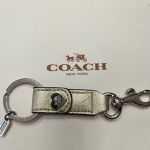 Coach gold metallic leather keychain silver hardware clip on interior of bag